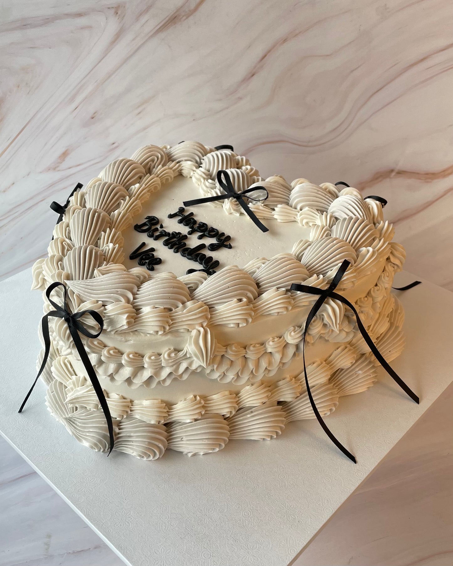 Ribbons and Bows Vintage heart cake in stone/beige with black bows side view