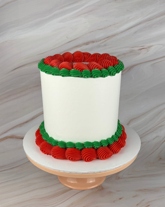 White cake with red and green piping (front view)